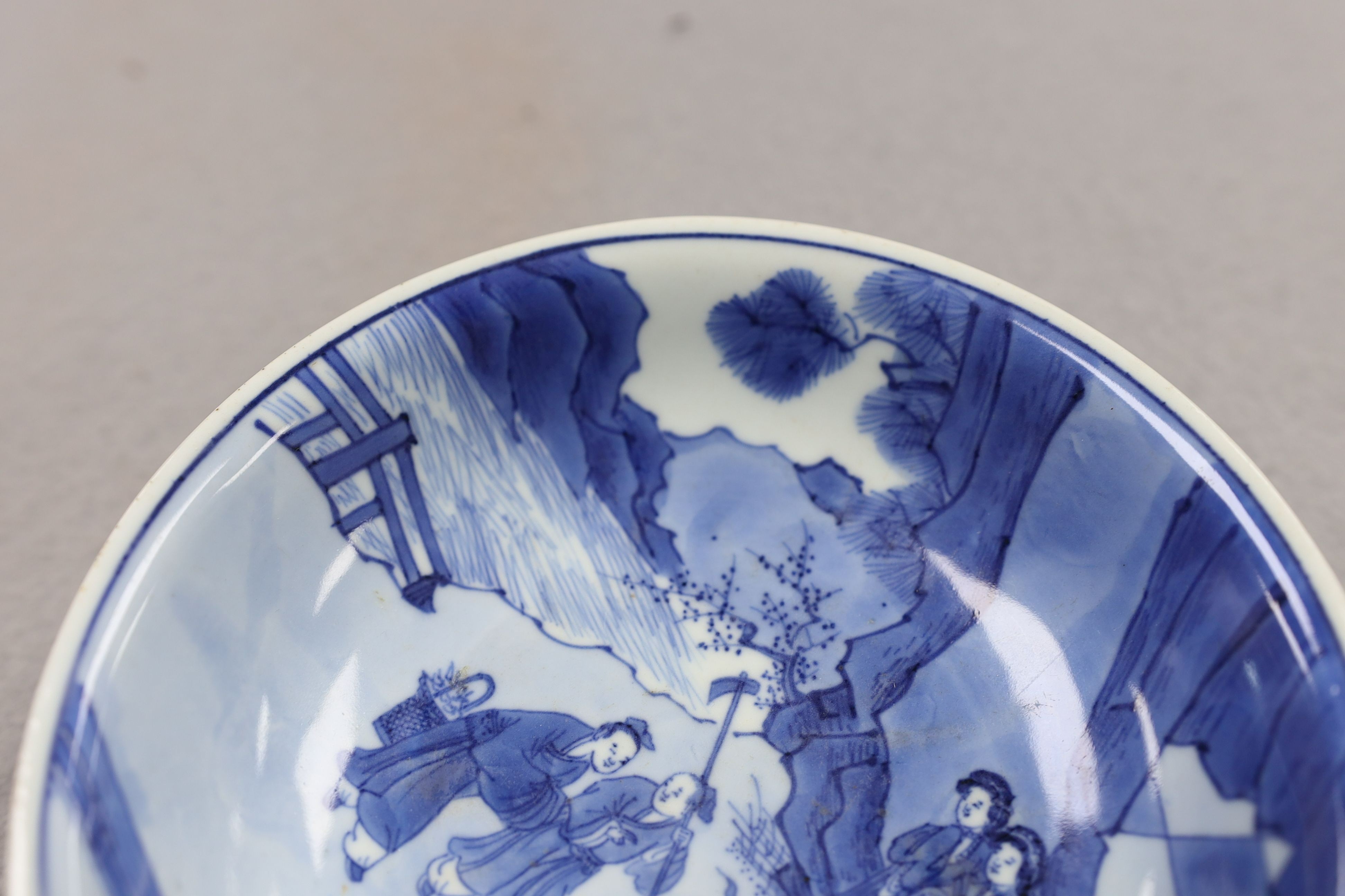 NB BOTH WITH HAIRLINE CRACKS A pair of Chinese blue and white small dishes, Kangxi six character marks and of the period (1662-1722), 15.7cm and 15.8cm diameter, foot later pierced, hairline cracks